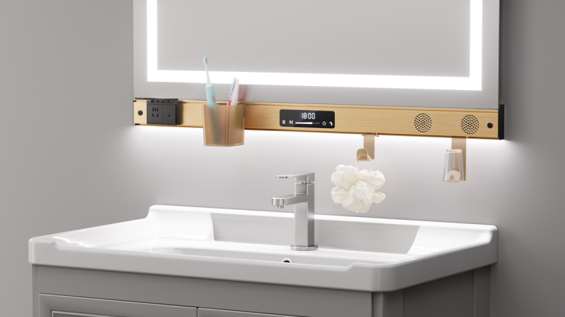 Wessel MIRA in Brushed Gold am Badspiegel, mit eingehängtem Becher und Haken, Licht auf die Wand gerichtet